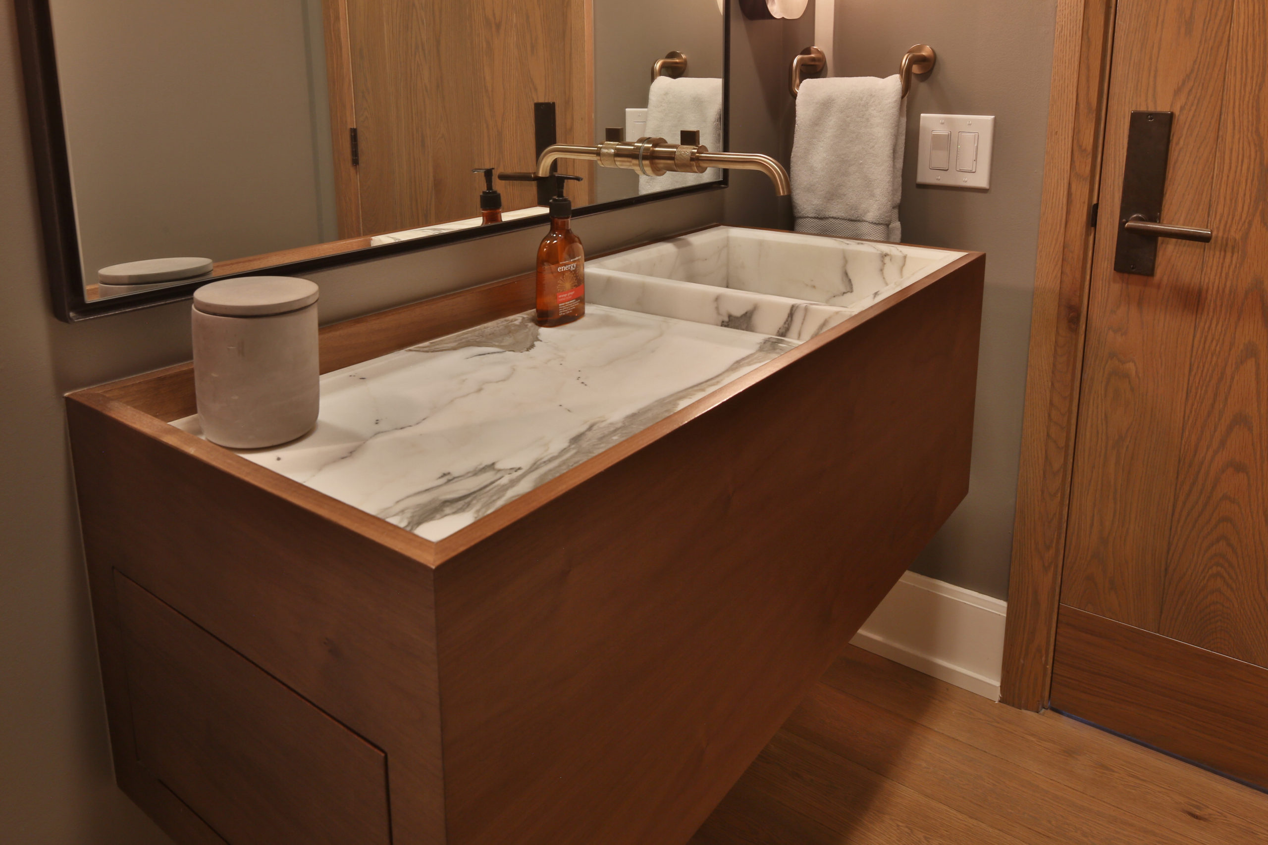Modern style sleek single vanity with right side sink and large counter space