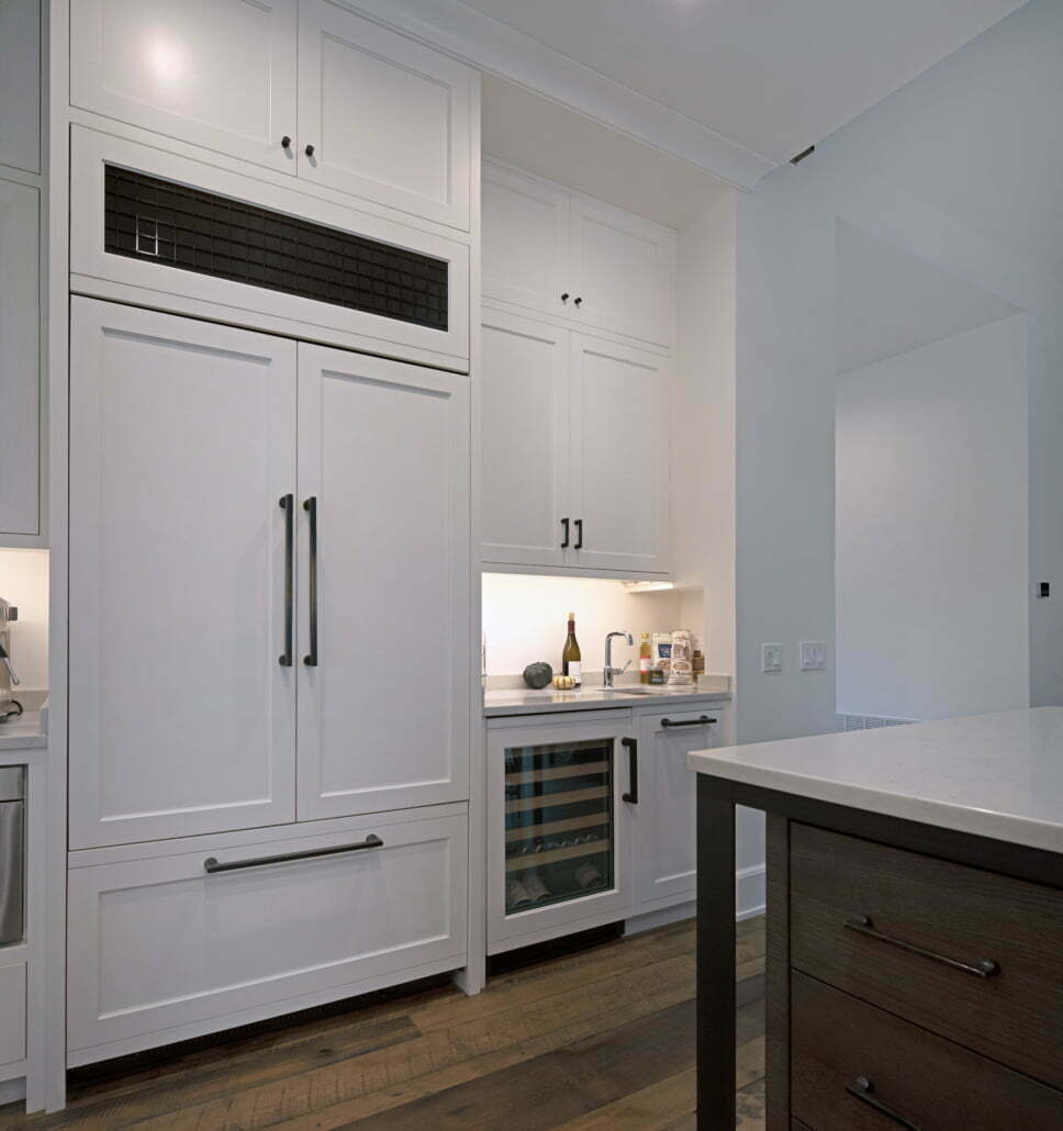 White shaker kitchen cabinet refrigerator and wine rack