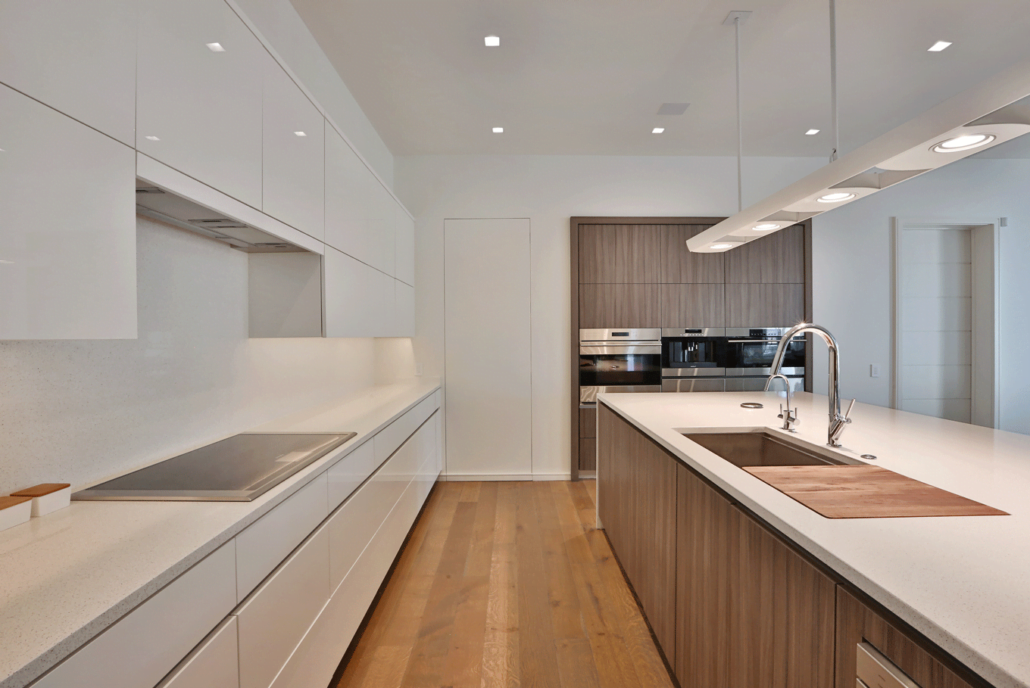 Modern minimalist style white kitchen cabinets with wood island