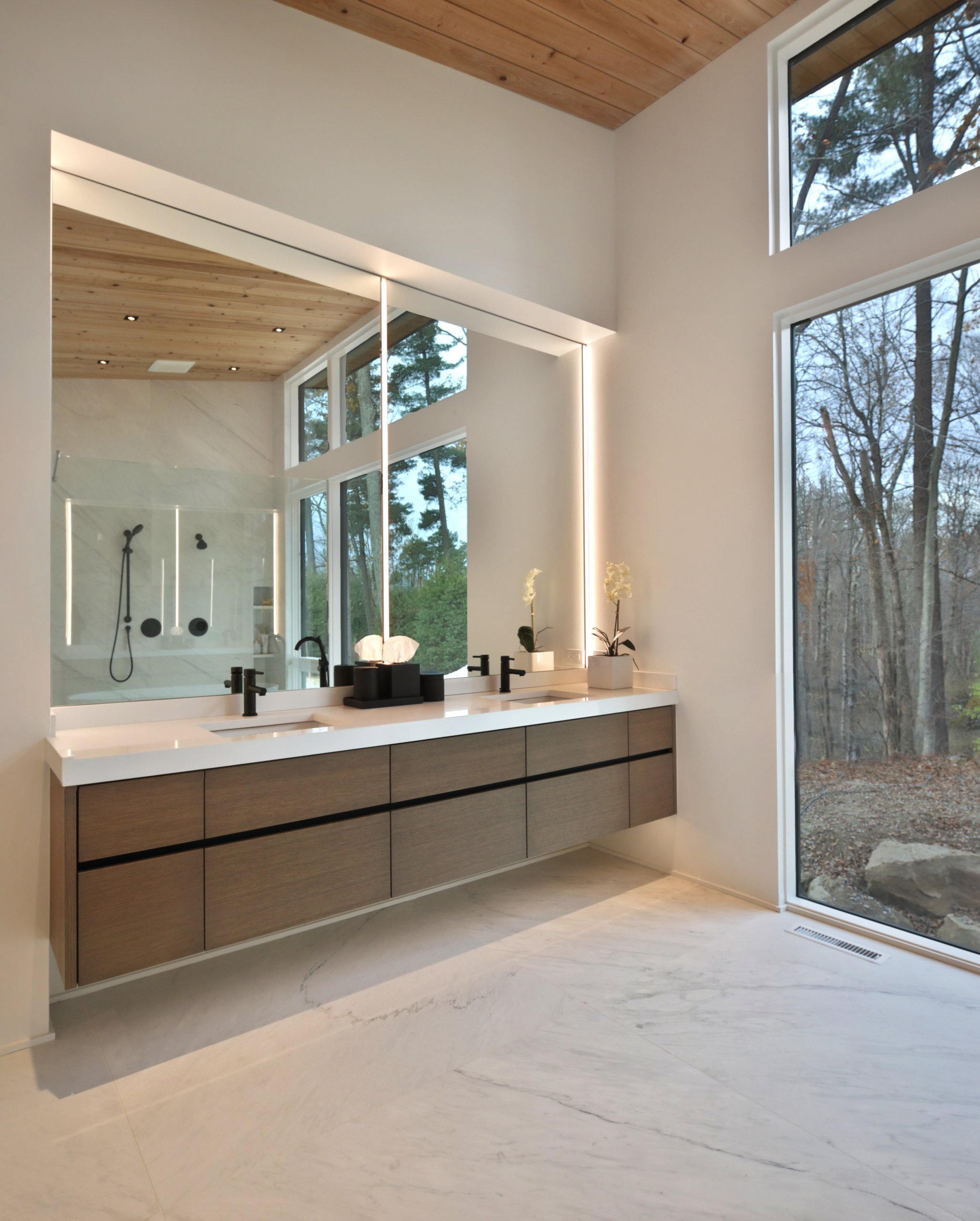 Owners bath with floating natural wood vanity